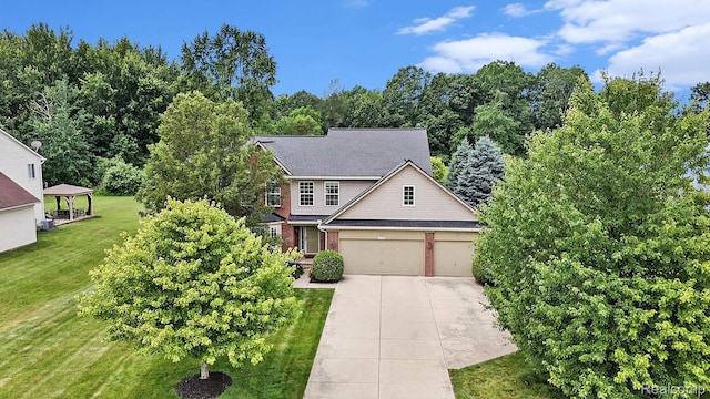 15740 Aspen Dr, Romulus, MI 48174 - traditional home with driveway, a front lawn, brick siding, and an attached garage