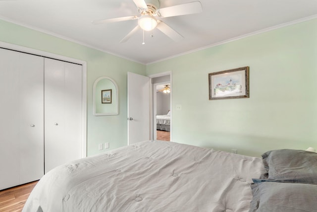 749 Foxboro Ct, Saline, MI 48176 - bedroom with light wood finished floors, ornamental molding, a closet, and a ceiling fan