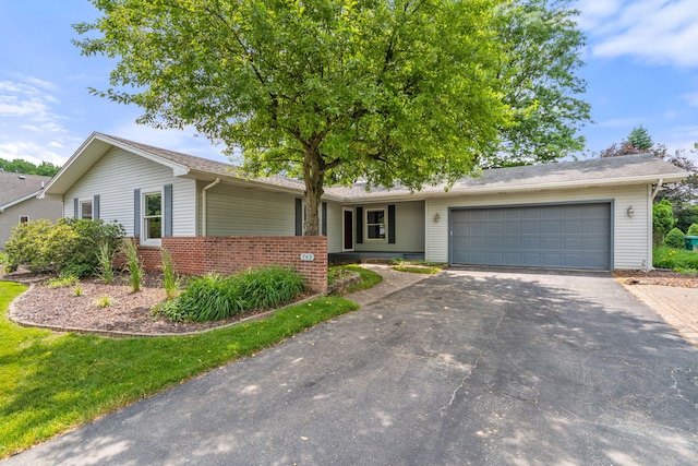 749 Foxboro Ct, Saline, MI 48176 - single story home with asphalt driveway, an attached garage, and brick siding
