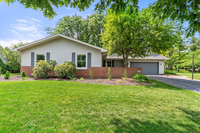 749 Foxboro Ct, Saline, MI 48176 - view of front facade featuring driveway, a garage, a front lawn, and brick siding