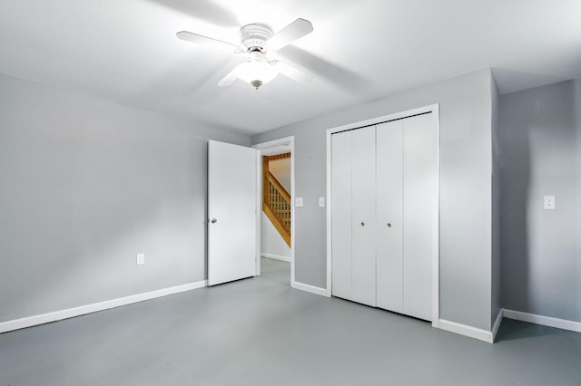 749 Foxboro Ct, Saline, MI 48176 - unfurnished bedroom with finished concrete flooring, a closet, and a ceiling fan