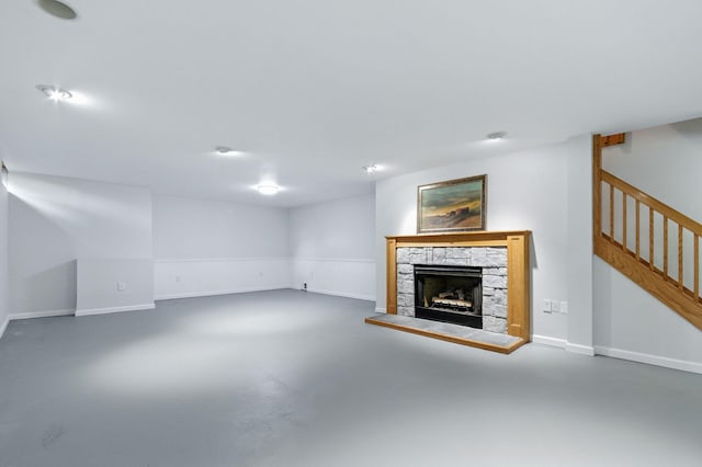 749 Foxboro Ct, Saline, MI 48176 - unfurnished living room featuring concrete floors, a stone fireplace, and stairway