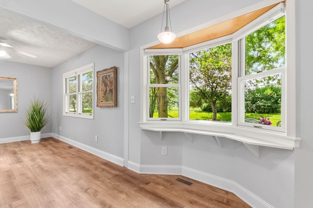 749 Foxboro Ct, Saline, MI 48176 - unfurnished dining area with wood finished floors and ceiling fan