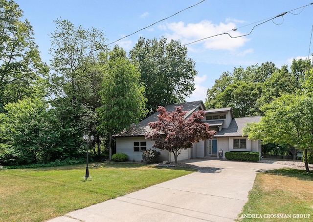 4343 N Lakeshore Dr, Holland, MI 49424 - obstructed view of property with driveway, a front lawn, a shingled roof, and an attached garage