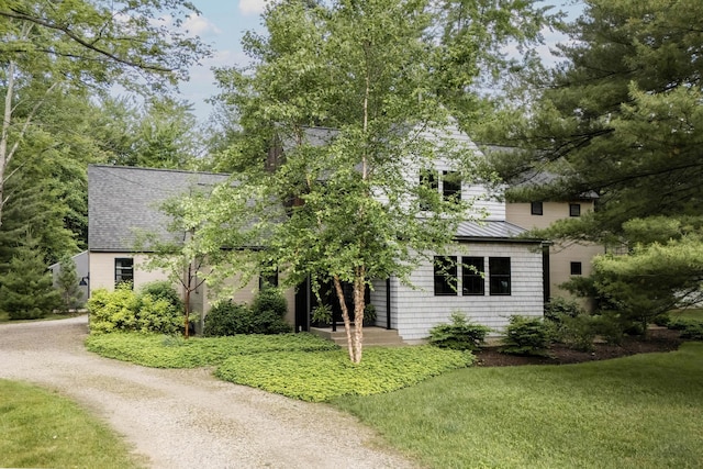 9435 Community Hall Rd, Union Pier, MI 49129 - view of property hidden behind natural elements featuring a metal roof and a front yard