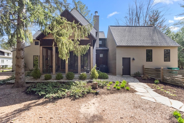 9435 Community Hall Rd, Union Pier, MI 49129 - view of front of home with a sunroom, a chimney, and a shingled roof