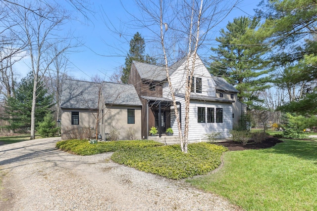 9435 Community Hall Rd, Union Pier, MI 49129 - view of front of home with driveway, a front lawn, and roof with shingles