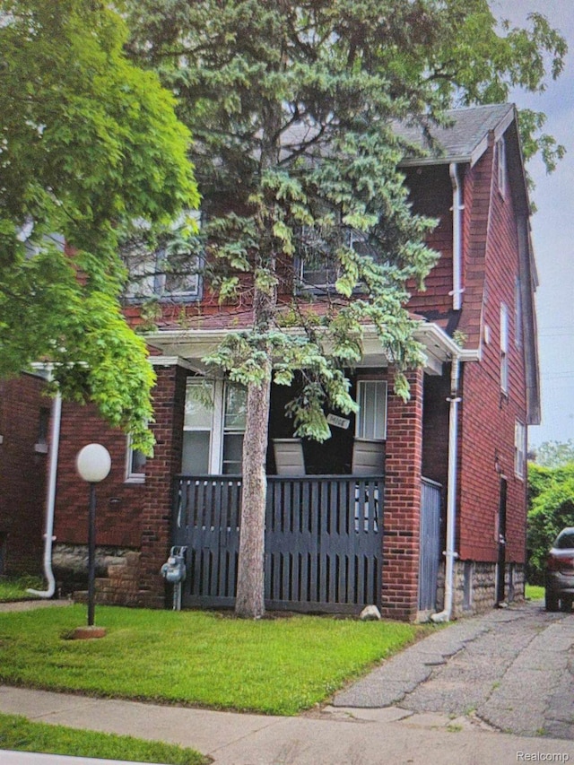 14108 Ardmore St, Detroit, MI 48227 - view of front facade featuring covered porch and brick siding