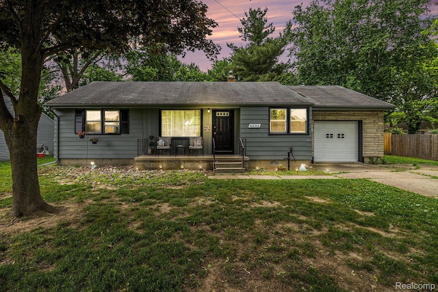 4292 Woodrow Ave, Burton, MI 48509 - single story home with driveway, an attached garage, and covered porch