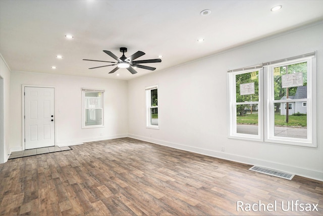 1676 Dyson St, Muskegon, MI 49442 - unfurnished room with healthy amount of natural light, recessed lighting, wood finished floors, ceiling fan, and ornamental molding