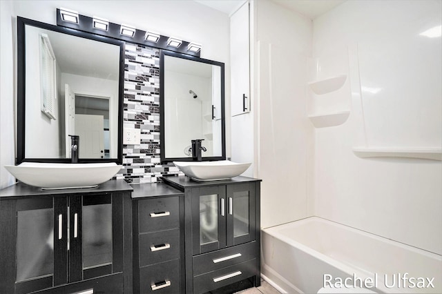 1676 Dyson St, Muskegon, MI 49442 - full bathroom featuring double vanity, tasteful backsplash, and shower / bathtub combination