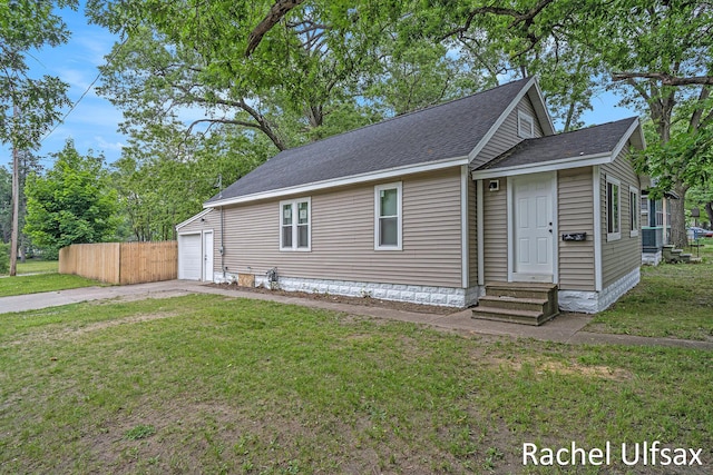 1676 Dyson St, Muskegon, MI 49442 - view of front of property featuring entry steps, driveway, roof with shingles, and a garage