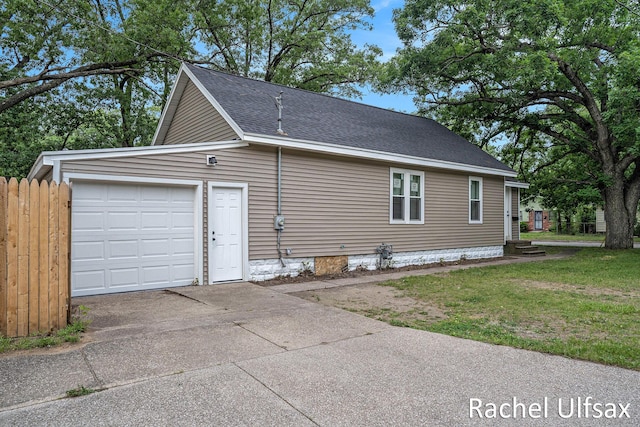 1676 Dyson St, Muskegon, MI 49442 - view of home's exterior featuring concrete driveway, an attached garage, and roof with shingles