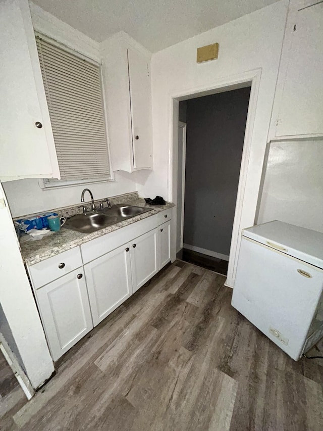 15345 Marlowe St, Detroit, MI 48227 - kitchen featuring fridge, dark wood-style flooring, white cabinets, and light countertops