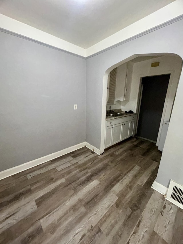 15345 Marlowe St, Detroit, MI 48227 - unfurnished dining area with arched walkways and dark wood-style floors