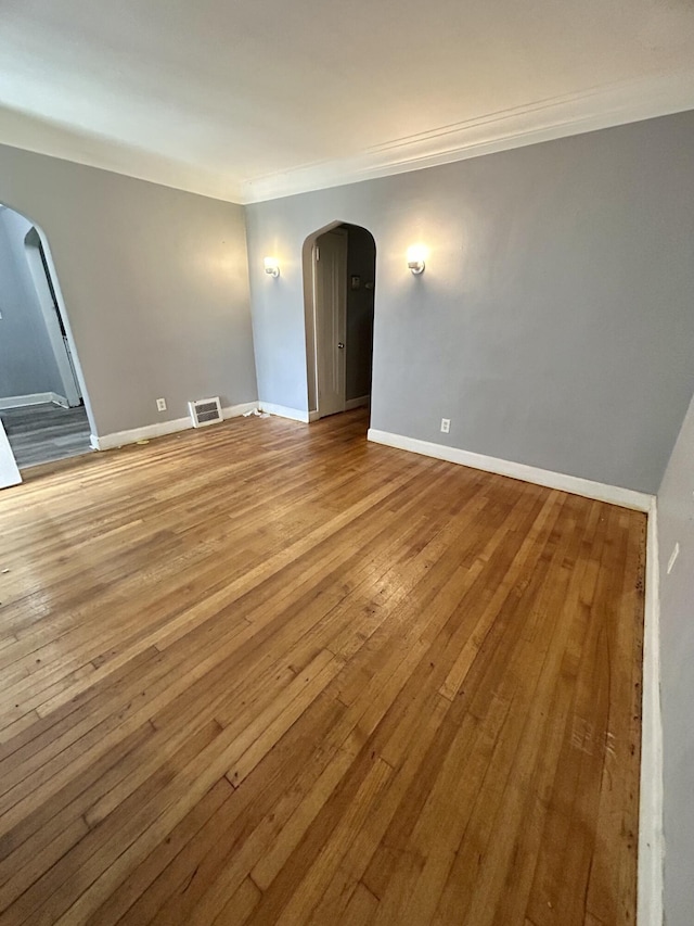 15345 Marlowe St, Detroit, MI 48227 - spare room with arched walkways, crown molding, and hardwood / wood-style floors
