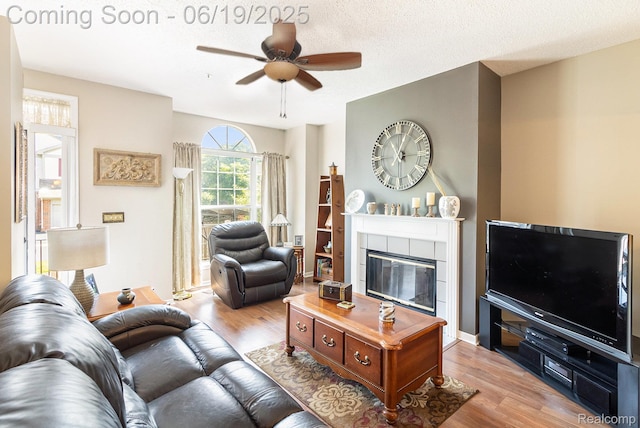 49649 Draper Cir, Plymouth, MI 48170 - living room with wood finished floors, a ceiling fan, and a tile fireplace