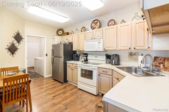 49649 Draper Cir, Plymouth, MI 48170 - kitchen featuring white appliances, washing machine and dryer, light wood-style floors, and light countertops