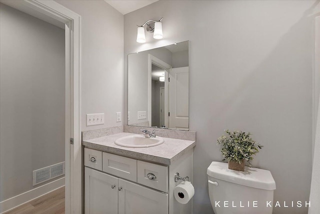 2519 Inverness Rd SE, Grand Rapids, MI 49546 - half bathroom featuring vanity and wood finished floors