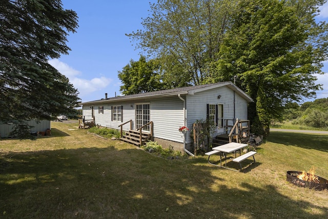 720 S 72nd Ave, Shelby, MI 49455 - back of property with a fire pit and a yard