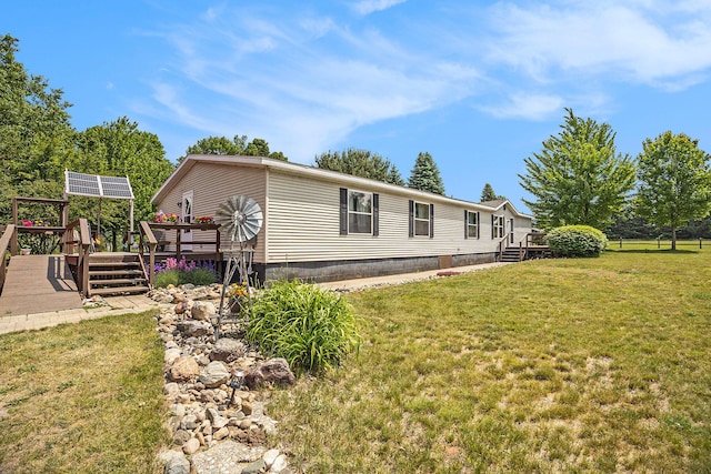 4890 W Birch Ln, Pentwater, MI 49449 - view of front of house with a deck and a front lawn