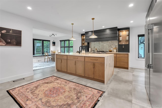 163 Manorwood Dr, Bloomfield Hills, MI 48304 - kitchen featuring high end fridge, wall chimney range hood, a kitchen island with sink, recessed lighting, and tasteful backsplash