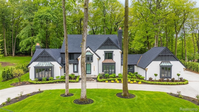 163 Manorwood Dr, Bloomfield Hills, MI 48304 - modern farmhouse with a chimney, curved driveway, a standing seam roof, and a front lawn