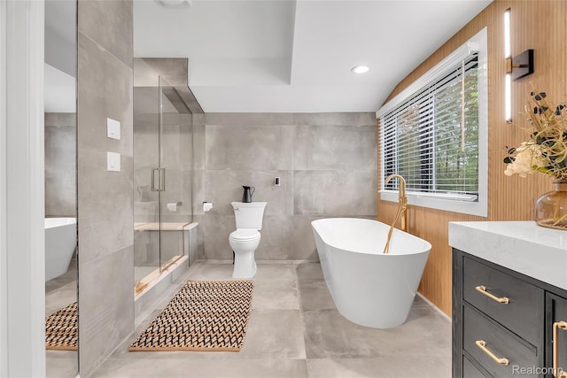 163 Manorwood Dr, Bloomfield Hills, MI 48304 - full bathroom with vanity, a freestanding bath, tile walls, and a stall shower