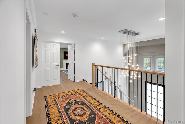 163 Manorwood Dr, Bloomfield Hills, MI 48304 - corridor featuring an upstairs landing, ornamental molding, wood finished floors, a chandelier, and recessed lighting