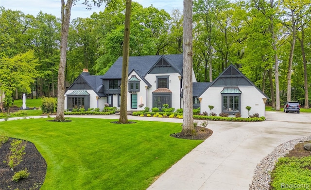 163 Manorwood Dr, Bloomfield Hills, MI 48304 - view of front of house with curved driveway, a balcony, a front yard, and view of wooded area