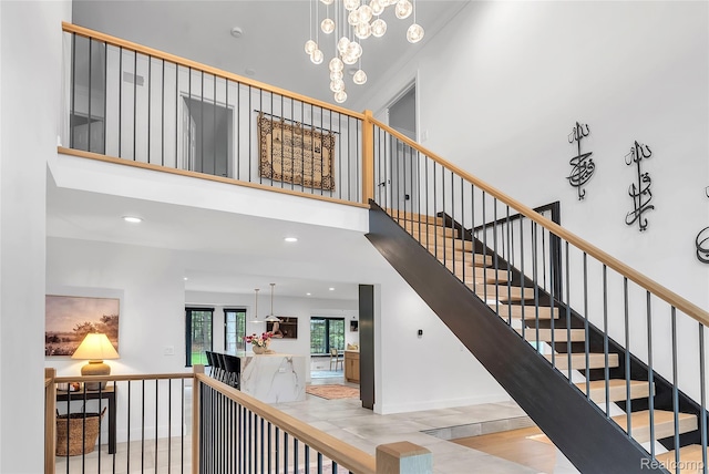 163 Manorwood Dr, Bloomfield Hills, MI 48304 - stairs with a towering ceiling, a chandelier, and recessed lighting
