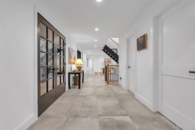 163 Manorwood Dr, Bloomfield Hills, MI 48304 - corridor featuring french doors, recessed lighting, stairs, and concrete flooring
