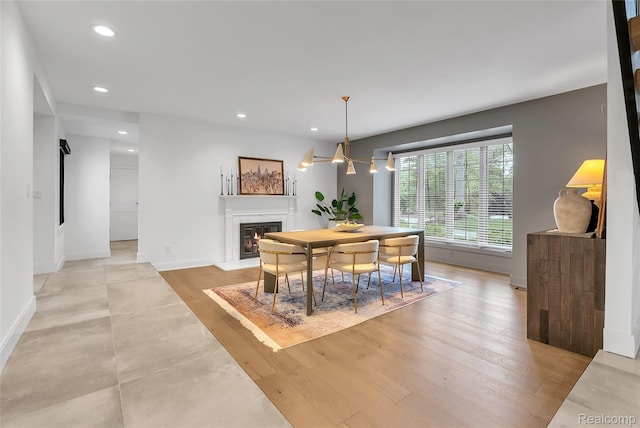 163 Manorwood Dr, Bloomfield Hills, MI 48304 - dining space featuring recessed lighting, a glass covered fireplace, and light wood finished floors