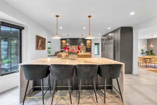 163 Manorwood Dr, Bloomfield Hills, MI 48304 - kitchen with high quality fridge, recessed lighting, light stone counters, a large island, and pendant lighting