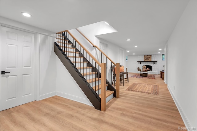 163 Manorwood Dr, Bloomfield Hills, MI 48304 - stairway featuring wood finished floors, recessed lighting, and a brick fireplace