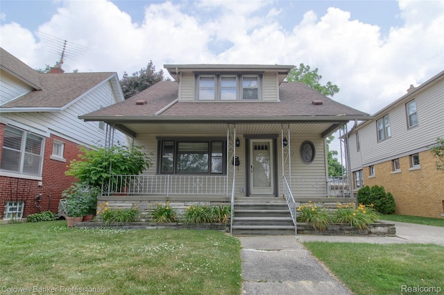 21732 Tenny St, Dearborn, MI 48124 - bungalow-style home with a porch, a front yard, and a shingled roof