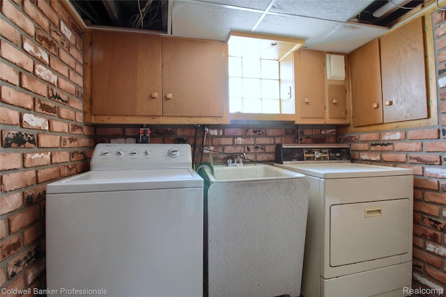 21732 Tenny St, Dearborn, MI 48124 - laundry area with cabinet space, separate washer and dryer, and brick wall