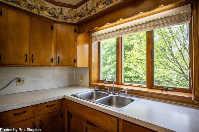 3193 W 112th St, Grant, MI 49327 - kitchen featuring light countertops, decorative backsplash, brown cabinets, and crown molding