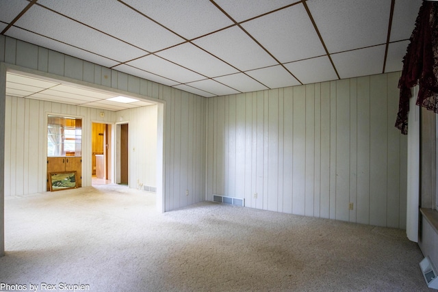 3193 W 112th St, Grant, MI 49327 - spare room with carpet floors, a drop ceiling, and wood walls