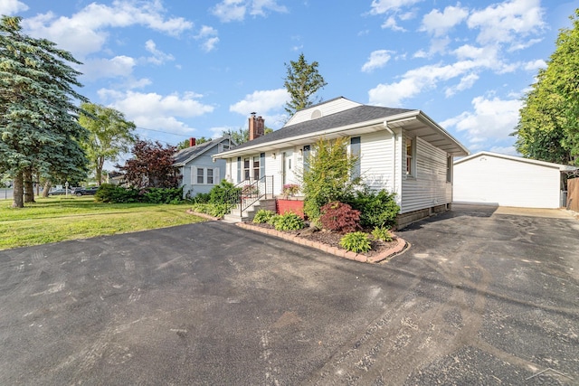 395 S Center Rd, Saginaw, MI 48638 - view of front of home featuring a chimney, a front yard, driveway, and roof with shingles
