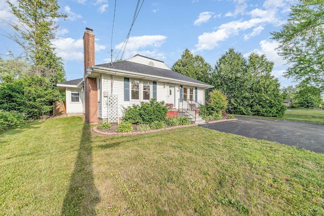 395 S Center Rd, Saginaw, MI 48638 - view of front of home featuring a chimney, driveway, and a front lawn