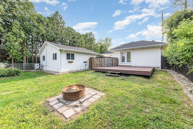 395 S Center Rd, Saginaw, MI 48638 - rear view of house featuring a fire pit, a wooden deck, and a fenced backyard
