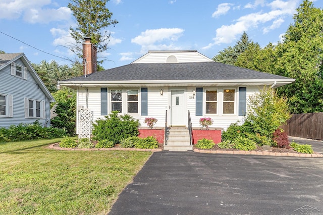 395 S Center Rd, Saginaw, MI 48638 - bungalow-style house featuring entry steps, a chimney, and roof with shingles