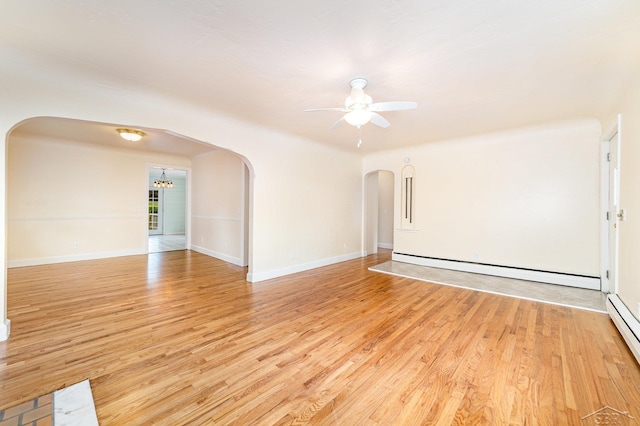 395 S Center Rd, Saginaw, MI 48638 - empty room featuring arched walkways, baseboard heating, light wood-style floors, a ceiling fan, and a chandelier