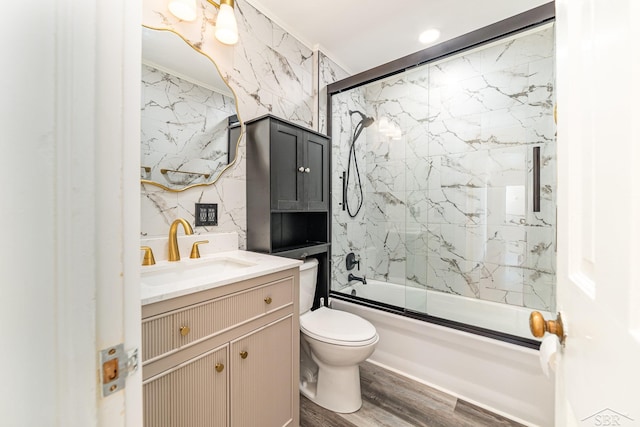 395 S Center Rd, Saginaw, MI 48638 - full bathroom featuring vanity, enclosed tub / shower combo, wood finished floors, and tile walls