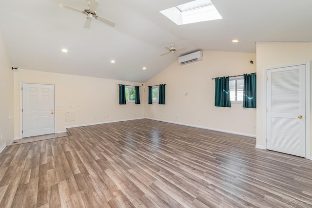 395 S Center Rd, Saginaw, MI 48638 - empty room featuring an AC wall unit, ceiling fan, a skylight, vaulted ceiling, and light wood-style flooring