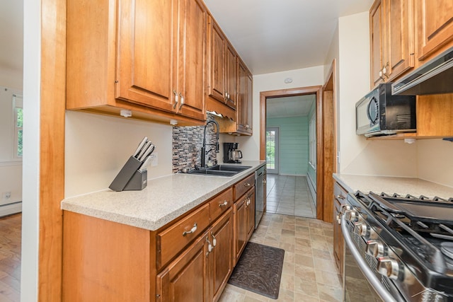 395 S Center Rd, Saginaw, MI 48638 - kitchen featuring appliances with stainless steel finishes, decorative backsplash, light countertops, and brown cabinets