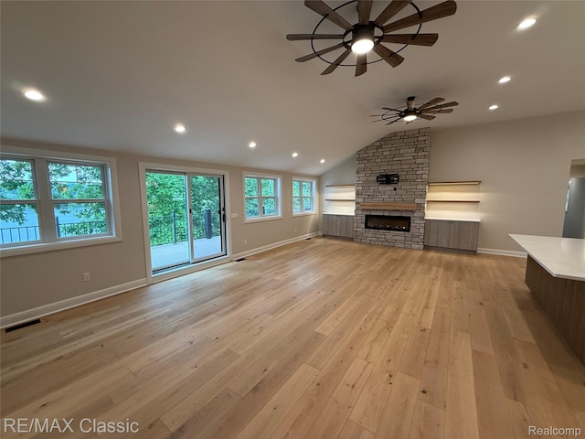 1420 Pettibone Lake Rd, Highland, MI 48356 - unfurnished living room featuring a ceiling fan, light wood finished floors, a fireplace, lofted ceiling, and recessed lighting