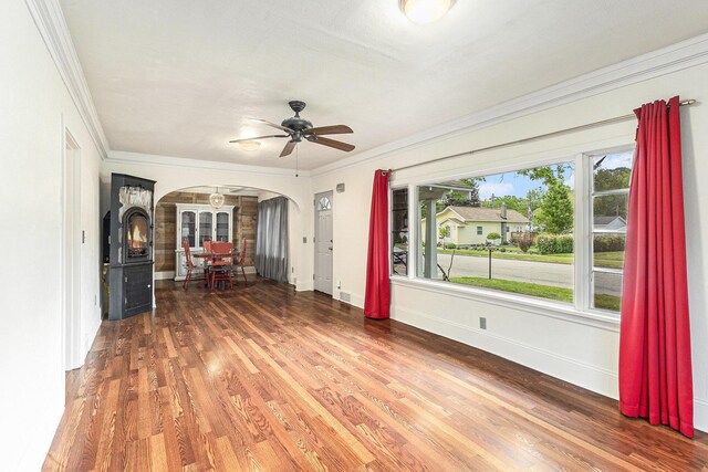101 E Whittier St, Ludington, MI 49431 - unfurnished room with arched walkways, ornamental molding, wood finished floors, and ceiling fan
