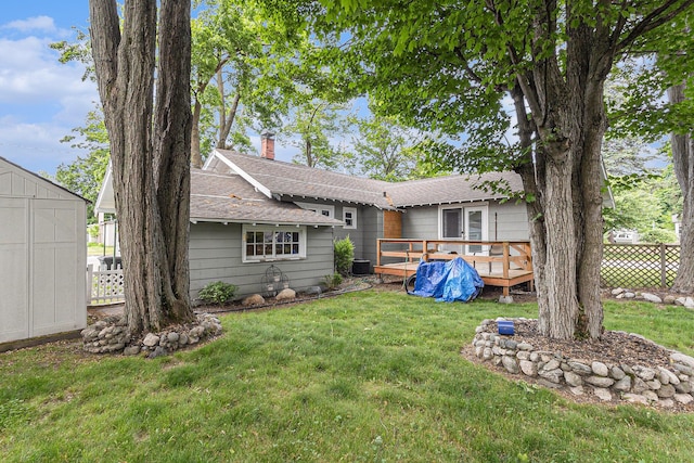 101 E Whittier St, Ludington, MI 49431 - back of house with a deck, a chimney, and a shingled roof